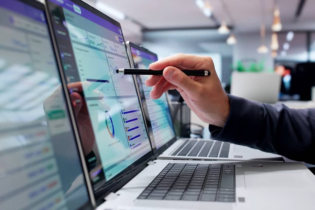 Businessman reviewing digital approval workflow tool on a laptop.